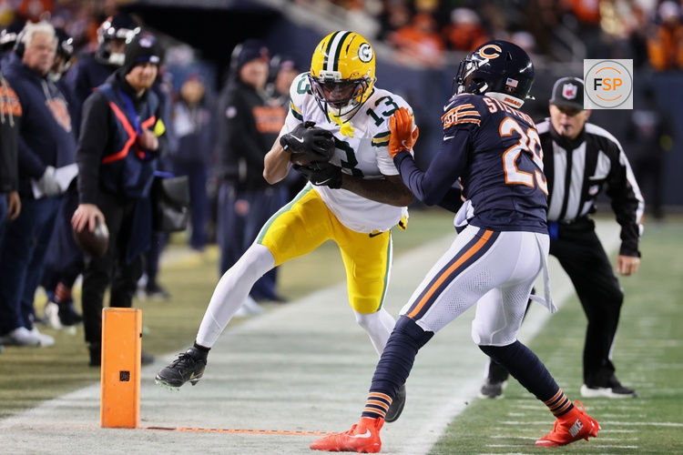 Dec 20, 2025; Chicago, Illinois, USA; Green Bay Packers wide receiver Dontayvion Wicks (13) runs out of bounds after catching a pass against Chicago Bears cornerback Tyrique Stevenson (29) during the second quarter at Soldier Field. Credit: Mike Dinovo-Imagn Images
