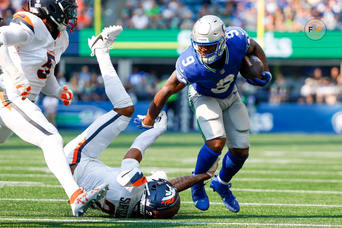 Sep 8, 2024; Seattle, Washington, USA; Seattle Seahawks running back Kenneth Walker III (9) breaks a tackle attempt by Denver Broncos cornerback Pat Surtain II (2) during the first quarter at Lumen Field. Credit: Joe Nicholson-Imagn Images