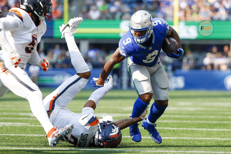 Sep 8, 2024; Seattle, Washington, USA; Seattle Seahawks running back Kenneth Walker III (9) breaks a tackle attempt by Denver Broncos cornerback Pat Surtain II (2) during the first quarter at Lumen Field. Credit: Joe Nicholson-Imagn Images