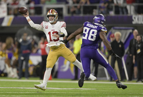 MINNEAPOLIS, MN - OCTOBER 23: San Francisco 49ers quarterback Brock Purdy (13) makes a pass as Minnesota Vikings linebacker D.J. Wonnum (98) gives chase during an NFL game between the Minnesota Vikings and San Francisco 49ers on October 23, 2023, at U.S. Bank Stadium in Minneapolis, MN.(Photo by Nick Wosika/Icon Sportswire)