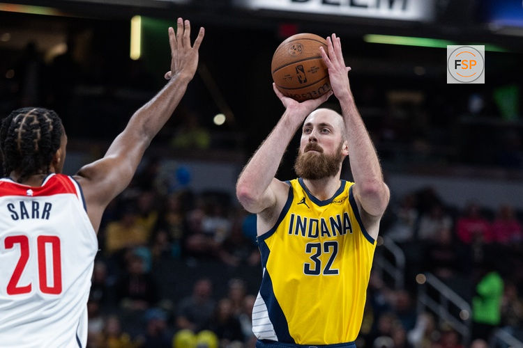 Nov 28, 2025; Indianapolis, Indiana, USA;  Indiana Pacers center Jay Huff (32) shoots the ball while Washington Wizards center Alex Sarr (20) defends in the first half at Gainbridge Fieldhouse. Credit: Trevor Ruszkowski-Imagn Images