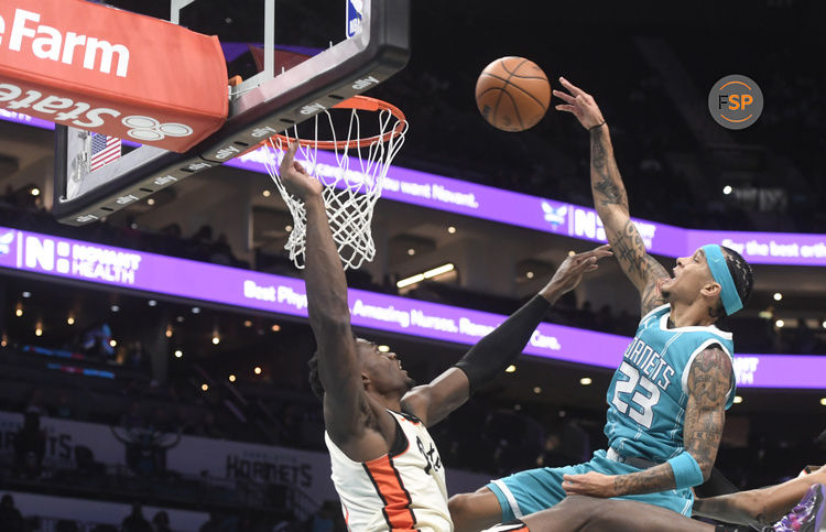 Nov 21, 2024; Charlotte, North Carolina, USA;  Charlotte Hornets guard Tre Mann (23) is fouled by Detroit Pistons center Jalen Duren (0) during the second half at the Spectrum Center. Credit: Sam Sharpe-Imagn Images