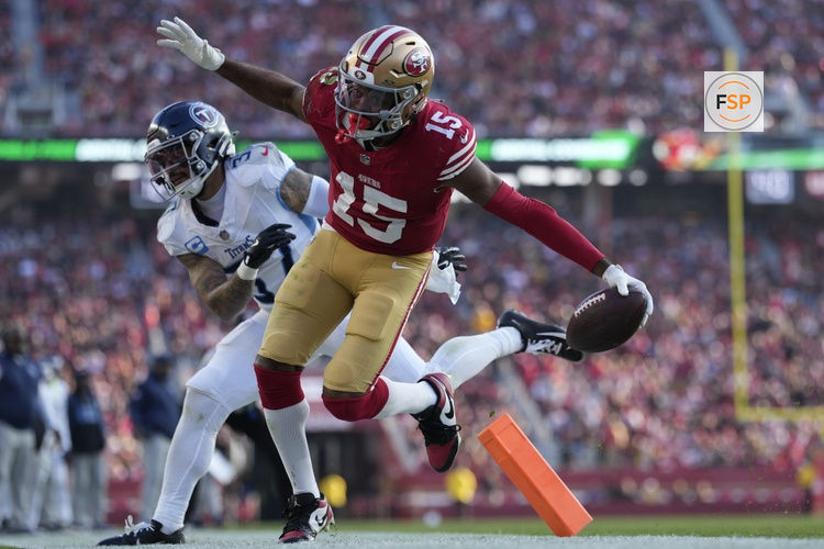 Dec 14, 2025; Santa Clara, California, USA;  San Francisco 49ers wide receiver Jauan Jennings (15) scores a touchdown against Tennessee Titans safety Amani Hooker (37) during the third quarter at Levi's Stadium. Credit: Kyle Terada-Imagn Images