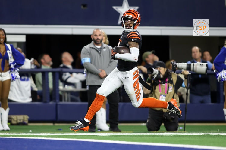 Dec 9, 2024; Arlington, Texas, USA; Cincinnati Bengals wide receiver Ja'Marr Chase (1) scores a touchdown against the Dallas Cowboys in the fourth quarter at AT&T Stadium. Credit: Tim Heitman-Imagn Images