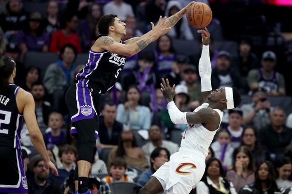 Feb 7, 2026; Sacramento, California, USA; Sacramento Kings guard Nique Clifford (5) blocks the shot from Cleveland Cavaliers guard Dennis Schroder (8) during the first quarter at Golden 1 Center. Mandatory Credit: Dennis Lee-Imagn Images