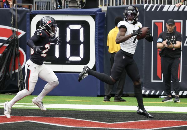 Sep 29, 2024; Houston, Texas, USA;  Jacksonville Jaguars wide receiver Brian Thomas Jr. (7) catches a touchdown against Houston Texans safety Eric Murray (23) in the first quarterat NRG Stadium. Mandatory Credit: Thomas Shea-Imagn Images