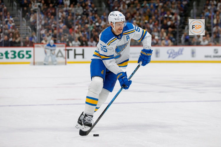 Dec 31, 2025; Denver, Colorado, USA; St. Louis Blues defenseman Colton Parayko (55) controls the puck in the first period against the Colorado Avalanche at Ball Arena. Credit: Isaiah J. Downing-Imagn Images