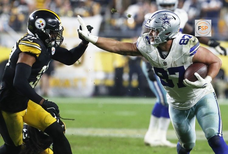Oct 6, 2024; Pittsburgh, Pennsylvania, USA;  Dallas Cowboys tight end Jake Ferguson (87) runs after a catch against the Pittsburgh Steelers Minkah Fitzpatrick (39) during the fourth quarter at Acrisure Stadium. Credit: Charles LeClaire-Imagn Images