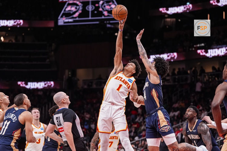 Jan 7, 2026; Atlanta, Georgia, USA; Atlanta Hawks forward Jalen Johnson (1) wins a jump ball against New Orleans Pelicans guard Micah Peavy (14) during the second half at State Farm Arena. Credit: Dale Zanine-Imagn Images