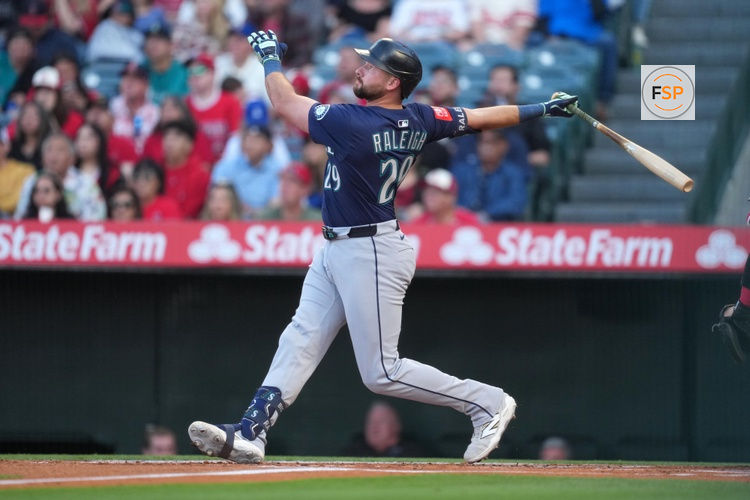 Jun 7, 2025; Anaheim, California, USA; Seattle Mariners catcher Cal Raleigh (29) hits a three-run home run in the first inning against the Los Angeles Angels at Angel Stadium. Credit: Kirby Lee-Imagn Images