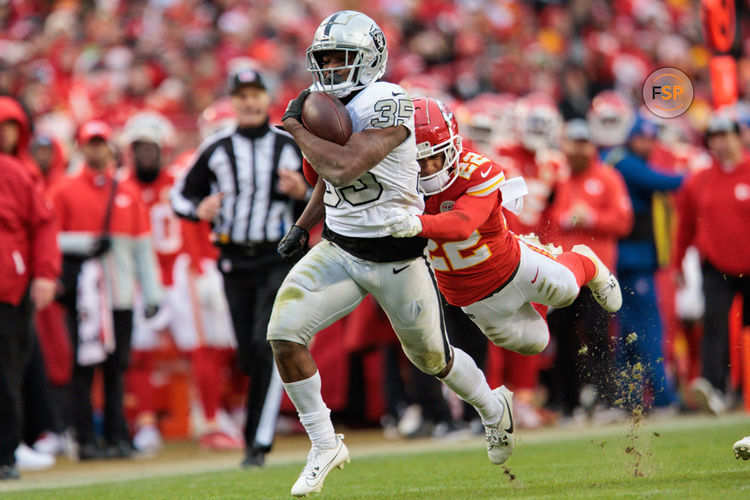 KANSAS CITY, MO - DECEMBER 25: Kansas City Chiefs cornerback Trent McDuffie (22) dives after Las Vegas Raiders running back Zamir White (35) during the second half on December 25th, 2023 at Arrowhead Stadium in Kansas City, Missouri. (Photo by William Purnell/Icon Sportswire)