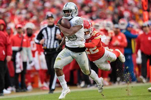 KANSAS CITY, MO - DECEMBER 25: Kansas City Chiefs cornerback Trent McDuffie (22) dives after Las Vegas Raiders running back Zamir White (35) during the second half on December 25th, 2023 at Arrowhead Stadium in Kansas City, Missouri. (Photo by William Purnell/Icon Sportswire)