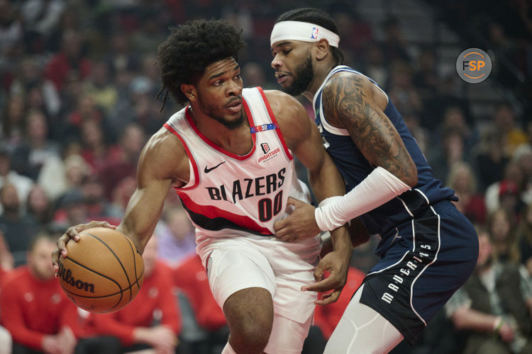 Dec 28, 2024; Portland, Oregon, USA; Portland Trail Blazers guard Scoot Henderson (00) passes the ball during the first half against Dallas Mavericks guard Jaden Hardy (1) at Moda Center. Credit: Troy Wayrynen-Imagn Images