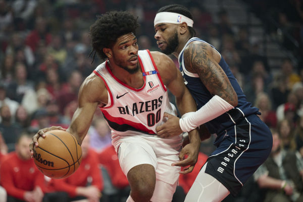 Dec 28, 2024; Portland, Oregon, USA; Portland Trail Blazers guard Scoot Henderson (00) passes the ball during the first half against Dallas Mavericks guard Jaden Hardy (1) at Moda Center. Mandatory Credit: Troy Wayrynen-Imagn Images