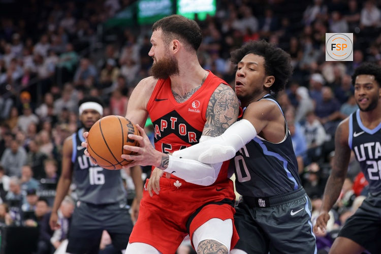 Mar 23, 2026; Salt Lake City, Utah, USA;  Utah Jazz guard Kennedy Chandler (0) reaches around Toronto Raptors forward/center Sandro Mamukelashvili (54) and tries to get to the ball during the second half at Delta Center. Credit: Chris Nicoll-Imagn Images