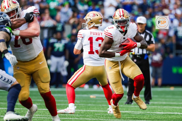 Sep 7, 2025; Seattle, Washington, USA; San Francisco 49ers running back Brian Robinson Jr. (3) rushes against the Seattle Seahawks during the fourth quarter at Lumen Field. Credit: Joe Nicholson-Imagn Images