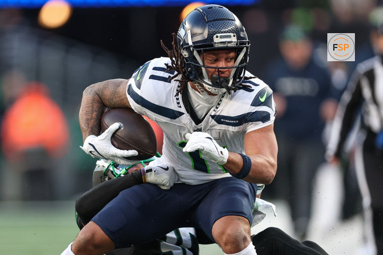 Dec 1, 2024; East Rutherford, New Jersey, USA; Seattle Seahawks wide receiver Jaxon Smith-Njigba (11) is tackled by New York Jets cornerback Michael Carter II (30) during the second half at MetLife Stadium. Credit: Vincent Carchietta-Imagn Images