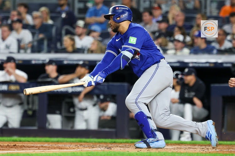 Oct 7, 2025; Bronx, New York, USA; Toronto Blue Jays outfielder Anthony Santander (25) hits a two-run RBI single in the third inning against the New York Yankees during game three of the ALDS round for the 2025 MLB playoffs at Yankee Stadium. Credit: Vincent Carchietta-Imagn Images