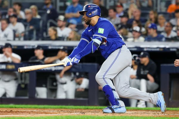 Oct 7, 2025; Bronx, New York, USA; Toronto Blue Jays outfielder Anthony Santander (25) hits a two-run RBI single in the third inning against the New York Yankees during game three of the ALDS round for the 2025 MLB playoffs at Yankee Stadium. Mandatory Credit: Vincent Carchietta-Imagn Images