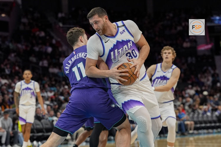 Nov 2, 2025; Charlotte, North Carolina, USA; Utah Jazz center Jusuf Nurkic (30) tries to elude Charlotte Hornets center Ryan Kalkbrenner (11) during the second half at Spectrum Center. Credit: Jim Dedmon-Imagn Images