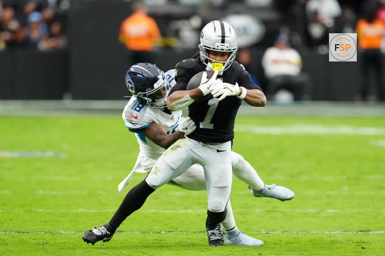 Oct 12, 2025; Paradise, Nevada, USA; Tennessee Titans Jalyn Armour-Davis (18) attempts a tackle on Las Vegas Raiders wide receiver Tre Tucker (1) during the second half at Allegiant Stadium. Credit: Stephen R. Sylvanie-Imagn Images
