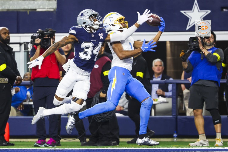 Dec 21, 2025; Arlington, Texas, USA; Los Angeles Chargers wide receiver Quentin Johnston (1) catches a touchdown pass against Dallas Cowboys cornerback Shavon Revel Jr. (34) during the first quarter at AT&T Stadium. Credit: Kevin Jairaj-Imagn Images