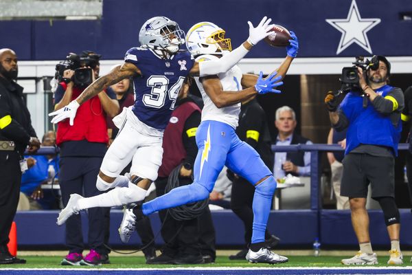 Dec 21, 2025; Arlington, Texas, USA; Los Angeles Chargers wide receiver Quentin Johnston (1) catches a touchdown pass against Dallas Cowboys cornerback Shavon Revel Jr. (34) during the first quarter at AT&T Stadium. Mandatory Credit: Kevin Jairaj-Imagn Images