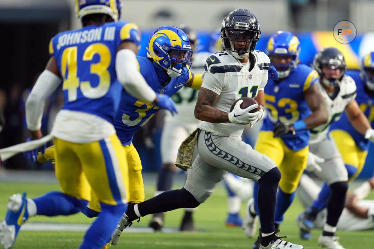 Nov 19, 2023; Inglewood, California, USA; Seattle Seahawks wide receiver Jaxon Smith-Njigba (11) runs against Los Angeles Rams safety Quentin Lake (37) in the first quarter at SoFi Stadium. Credit: Kirby Lee-USA TODAY Sports