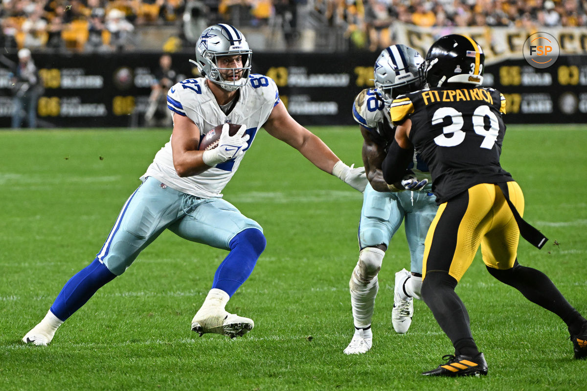 Oct 6, 2024; Pittsburgh, Pennsylvania, USA; Dallas Cowboys tight end Jake Ferguson (87) eludes PPittsburgh Steelers safety Minkah Fitzpatrick (39) during the second quarter at Acrisure Stadium. Credit: Barry Reeger-Imagn Images





