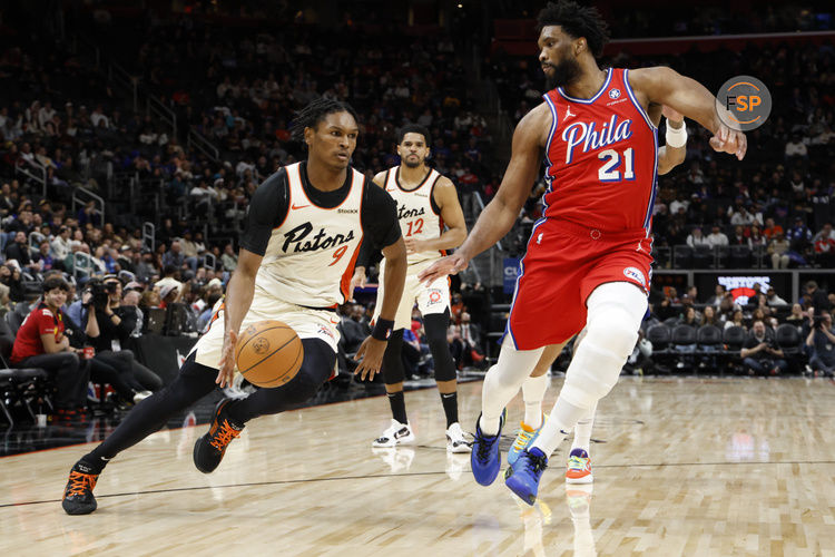 Feb 7, 2025; Detroit, Michigan, USA;  Detroit Pistons forward Ausar Thompson (9) dribbles on Philadelphia 76ers center Joel Embiid (21) in the second half at Little Caesars Arena. Credit: Rick Osentoski-Imagn Images