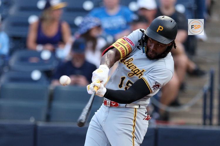 Mar 31, 2025; St. Petersburg, Florida, USA; Pittsburgh Pirates center fielder Oneil Cruz (15) hits a base hit against the Tampa Bay Rays in the first inning at George M. Steinbrenner Field. Credit: Nathan Ray Seebeck-Imagn Images