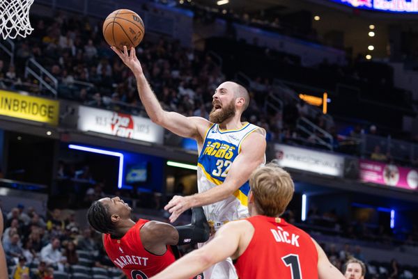 Nov 15, 2025; Indianapolis, Indiana, USA;  Indiana Pacers center Jay Huff (32) shoots the ball while Toronto Raptors forward/guard RJ Barrett (9) defends in the second half at Gainbridge Fieldhouse. Mandatory Credit: Trevor Ruszkowski-Imagn Images