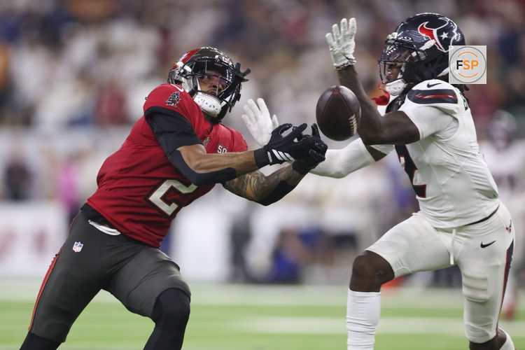 Sep 15, 2025; Houston, Texas, USA; Tampa Bay Buccaneers wide receiver Emeka Egbuka (2) attempts to make a catch as Houston Texans safety Calen Bullock (2) defends during the fourth quarter at NRG Stadium. Credit: Troy Taormina-Imagn Images