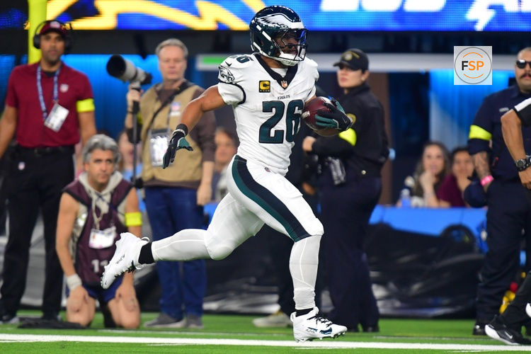 Dec 8, 2025; Inglewood, California, USA; Philadelphia Eagles running back Saquon Barkley (26) runs for a touchdown against the Los Angeles Chargers in the second half at SoFi Stadium. Credit: Gary A. Vasquez-Imagn Images