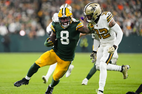 Dec 23, 2024; Green Bay, Wisconsin, USA;  Green Bay Packers running back Josh Jacobs (8) stiff arms New Orleans Saints safety Tyrann Mathieu (32) during the first quarter  at Lambeau Field. Mandatory Credit: Jeff Hanisch-Imagn Images