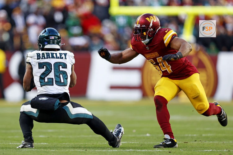 Dec 22, 2024; Landover, Maryland, USA; Philadelphia Eagles running back Saquon Barkley (26) drops a pass against Washington Commanders linebacker Bobby Wagner (54) during the fourth quarter at Northwest Stadium. Credit: Peter Casey-Imagn Images