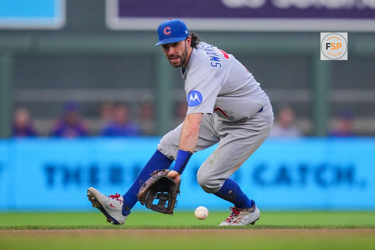 Jul 8, 2025; Minneapolis, Minnesota, USA;  Chicago Cubs shortstop Dansby Swanson (7) fields a ground ball against the Minnesota Twins in the seventh inning at Target Field. Credit: Brad Rempel-Imagn Images