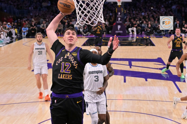 Jan 2, 2026; Los Angeles, California, USA;Los Angeles Lakers forward Jake Laravia (12) goes up for a dunk during the first half against the Memphis Grizzlies at Crypto.com Arena. Credit: Jayne Kamin-Oncea-Imagn Images