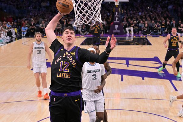 Jan 2, 2026; Los Angeles, California, USA;Los Angeles Lakers forward Jake Laravia (12) goes up for a dunk during the first half against the Memphis Grizzlies at Crypto.com Arena. Mandatory Credit: Jayne Kamin-Oncea-Imagn Images