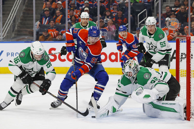 Mar 26, 2025; Edmonton, Alberta, CAN; Dallas Stars goaltender Jake Oettinger (29) makes a save on Edmonton Oilers forward Ryan Nugent-Hopkins (93) during the third period at Rogers Place. Credit: Perry Nelson-Imagn Images