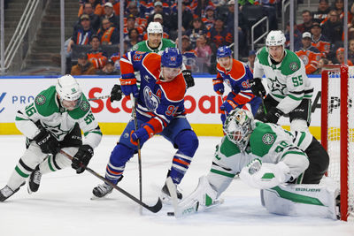 Mar 26, 2025; Edmonton, Alberta, CAN; Dallas Stars goaltender Jake Oettinger (29) makes a save on Edmonton Oilers forward Ryan Nugent-Hopkins (93) during the third period at Rogers Place. Mandatory Credit: Perry Nelson-Imagn Images