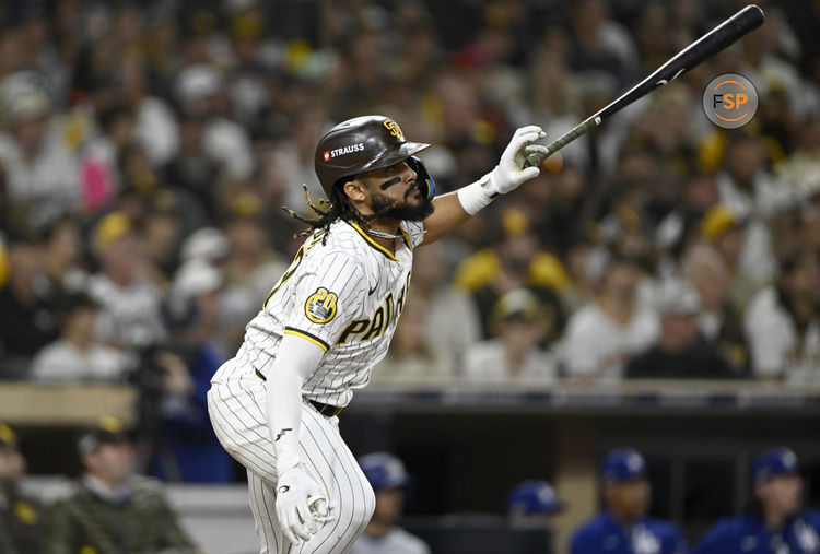 Oct 9, 2024; San Diego, California, USA; San Diego Padres outfielder Fernando Tatis Jr. (23) doubles in the third inning against the Los Angeles Dodgers during game four of the NLDS for the 2024 MLB Playoffs at Petco Park.  Credit: Denis Poroy-Imagn Images