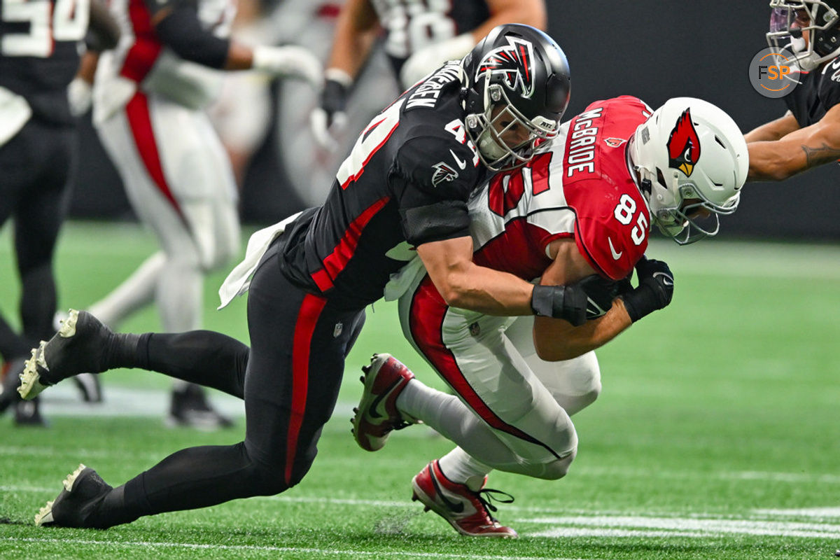 ATLANTA, GA – JANUARY 01:  Arizona tight end Trey McBride (85) is tackled by Atlanta linebacker Troy Andersen (44) during the NFL game between the Arizona Cardinals and the Atlanta Falcons on January 1st, 2023 at Mercedes-Benz Stadium in Atlanta, GA.  (Photo by Rich von Biberstein/Icon Sportswire)