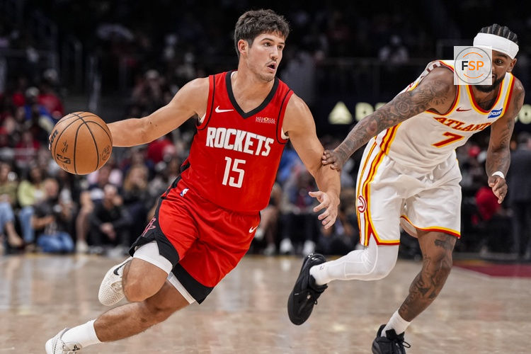 Oct 16, 2025; Atlanta, Georgia, USA; Houston Rockets guard Reed Sheppard (15) dribbles past Atlanta Hawks guard Nickeil Alexander-Walker (7) during the second half at State Farm Arena. Credit: Dale Zanine-Imagn Images