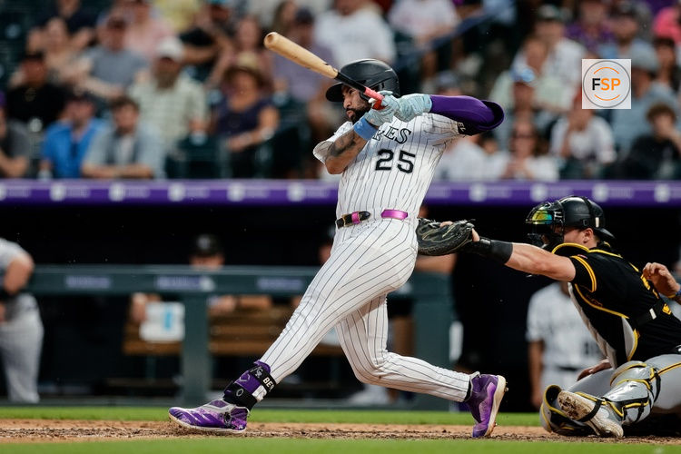 Aug 2, 2025; Denver, Colorado, USA; Colorado Rockies first baseman Warming Bernabel (25) hits an RBI single in the seventh inning against the Pittsburgh Pirates at Coors Field. Credit: Isaiah J. Downing-Imagn Images