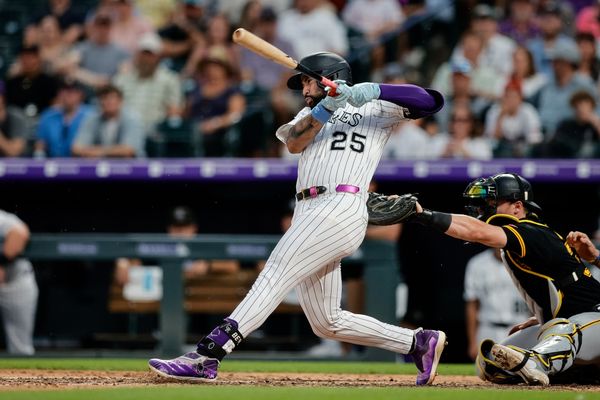 Aug 2, 2025; Denver, Colorado, USA; Colorado Rockies first baseman Warming Bernabel (25) hits an RBI single in the seventh inning against the Pittsburgh Pirates at Coors Field. Mandatory Credit: Isaiah J. Downing-Imagn Images