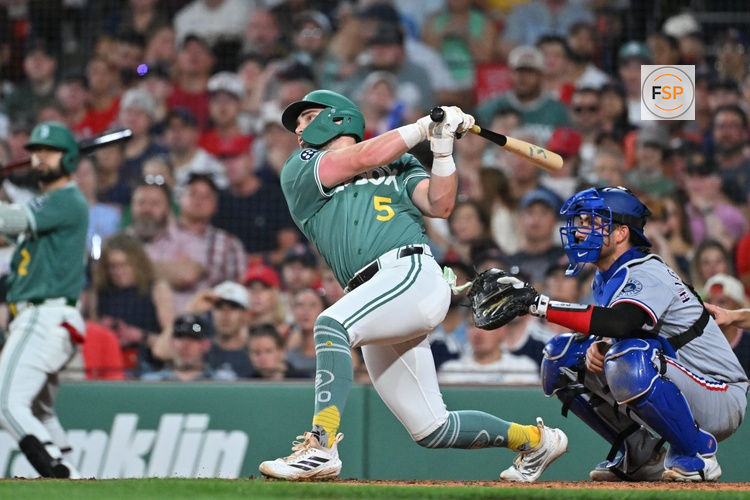 Jun 12, 2026; Boston, Massachusetts, USA; Boston Red Sox third baseman Caleb Durbin (5) hits a sacrifice fly ball to bring first baseman Willson Contreras (40) (not pictured) in for a run against the Texas Rangers during the fifth inning at Fenway Park. Credit: Eric Canha-Imagn Images