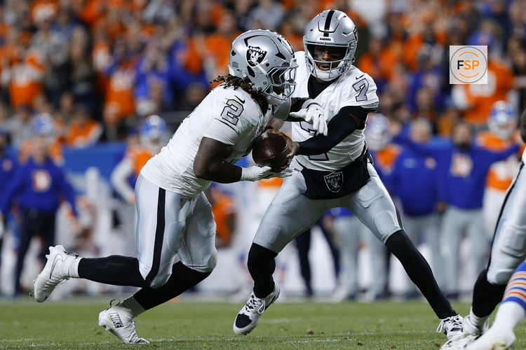 Nov 6, 2025; Denver, Colorado, USA; Las Vegas Raiders quarterback Geno Smith (7) hands the ball to running back Ashton Jeanty (2) during the first half at Empower Field at Mile High. Credit: Isaiah J. Downing-Imagn Images