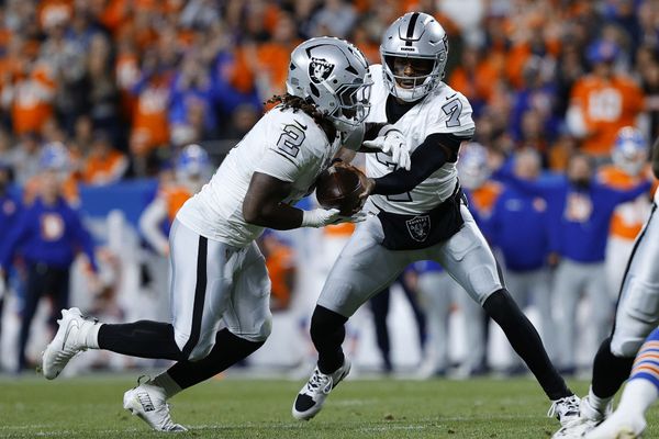 Nov 6, 2025; Denver, Colorado, USA; Las Vegas Raiders quarterback Geno Smith (7) hands the ball to running back Ashton Jeanty (2) during the first half at Empower Field at Mile High. Mandatory Credit: Isaiah J. Downing-Imagn Images