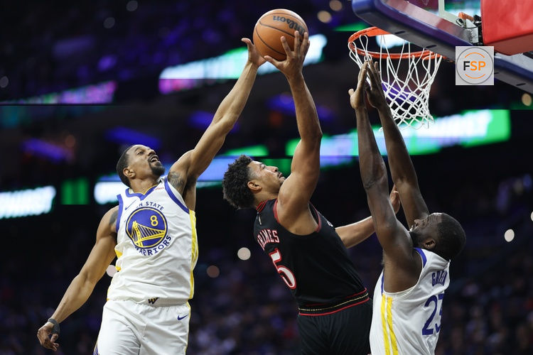 Dec 4, 2025; Philadelphia, Pennsylvania, USA; Philadelphia 76ers guard Quentin Grimes (5) drives for a score between Golden State Warriors guard De'Anthony Melton (8) and forward Draymond Green (23) during the second quarter at Xfinity Mobile Arena. Credit: Bill Streicher-Imagn Images